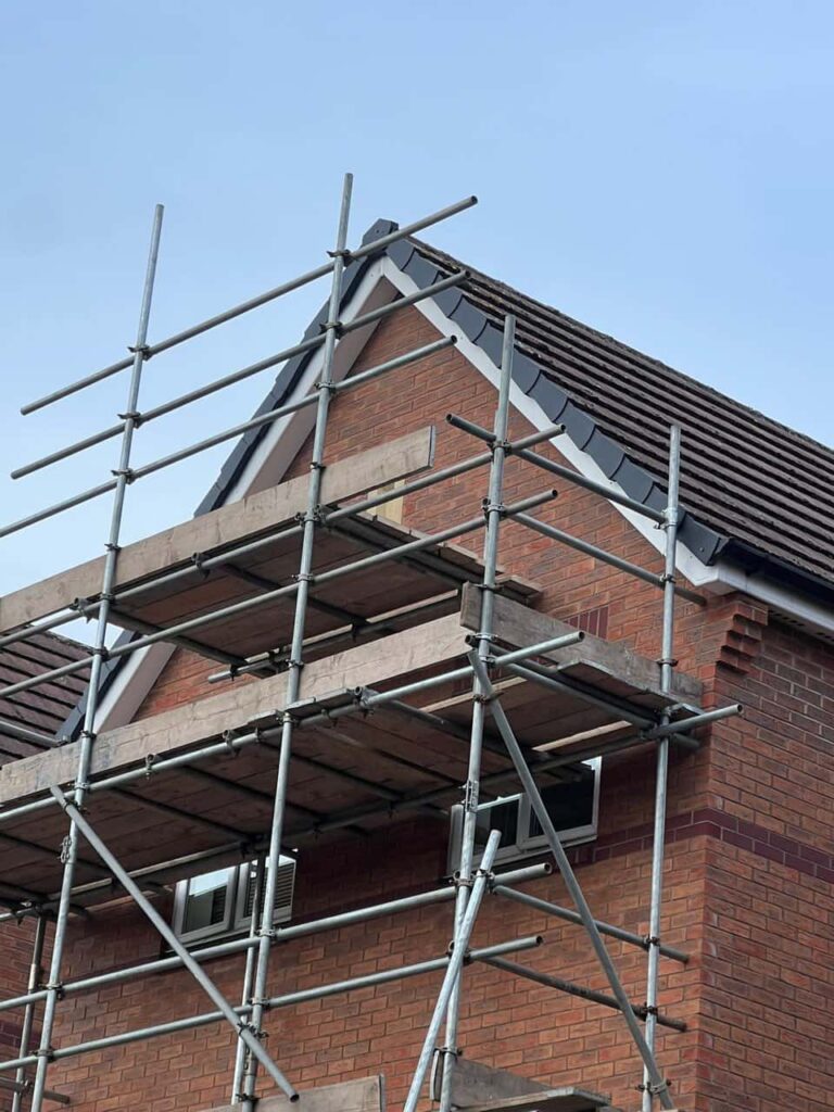 This is a photo of a roof which has just been repaired. There is a scaffold located at the gable end for access onto the roof. Works carried out by Sidcup Roofing Repairs