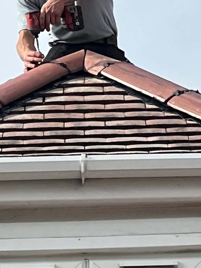 This is a photo of one of the operatives of Sidcup Roofing Repairs installing new ridge tiles